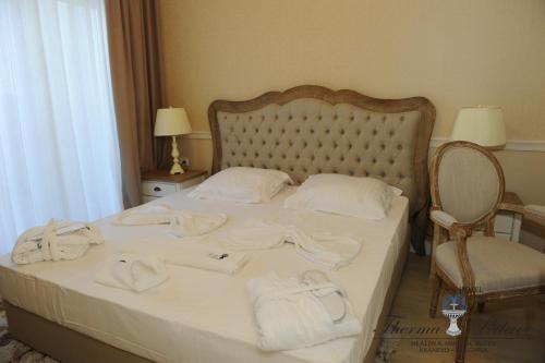 a bedroom with a bed with towels on it at Therma Palace - All inclusive & Private Beach & Free Parking in Kranevo