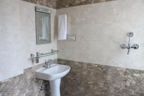 a bathroom with a sink and a mirror at Hotel Family Ties Pvt. Ltd. in Kathmandu