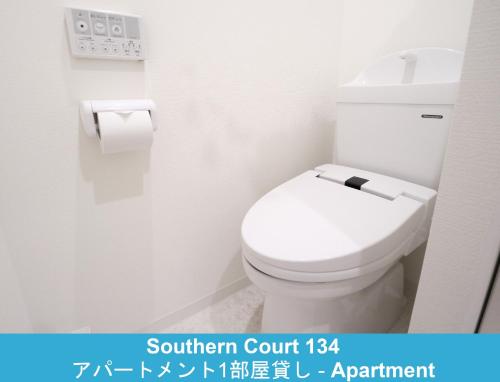 a bathroom with a white toilet in a room at Enoshima Guest House 134 in Fujisawa
