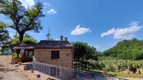 a small building with a fence around it at Agriturismo Pascucci in Tolentino