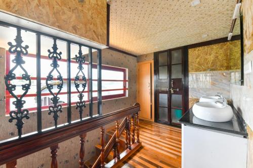 a bathroom with a sink and a window at Beach Paradise Day Cruise Houseboat in Alleppey