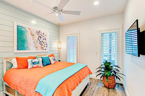 a bedroom with a bed and a ceiling fan at Golf Course Living at Palmilla Beach in Port Aransas