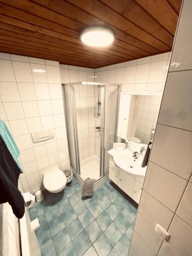 a bathroom with a shower and a toilet and a sink at Pension Kreuzeck - Dein Glücksplatz am Lech in Weissenbach am Lech