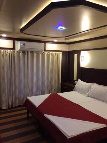 a bedroom with a large bed in a room at Beach Paradise Day Cruise Houseboat in Alleppey