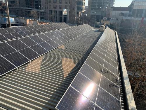 a group of solar panels on the roof of a building at President Hotel by Hrazdan Hotel CJSC in Yerevan