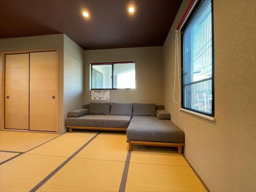 a living room with a couch and a window at COTO Tokyo Asakusa 5 in Tokyo