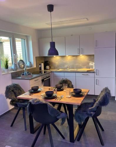 a kitchen with a wooden table and chairs in a kitchen at Ferienwohnung Behnke in Brand