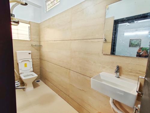 a bathroom with a sink and a toilet at Vedganga Villa - Homestay in Kolhapur