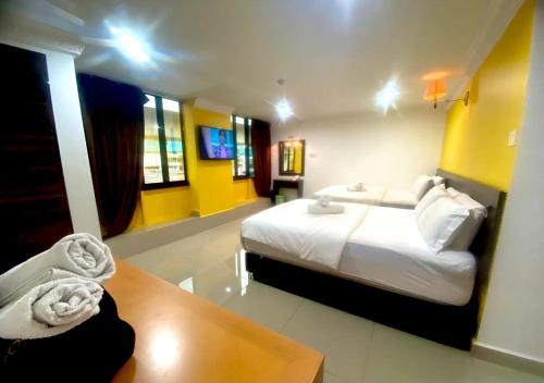 a hotel room with a bed and a table at N HIBISCUS HOTEL in Seri Kembangan