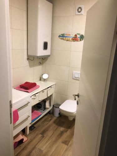 a small bathroom with a toilet and a sink at Apartment Your Home in Dobra Voda