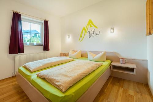 a bedroom with a large bed in a room at Aparthotel Hummerau in Alpbach
