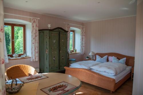 a bedroom with a bed and a coffee table and a table at Almbauernhof in Ruhpolding