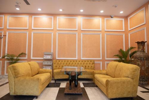 a living room with two chairs and a table at Golden Parkk Hotel in Kolkata