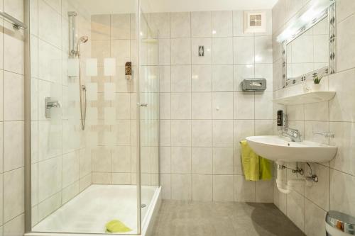 a bathroom with a shower and a sink at Aparthotel Hummerau in Alpbach
