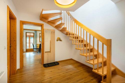 a wooden staircase in a home with a hallway at Aparthotel Hummerau in Alpbach
