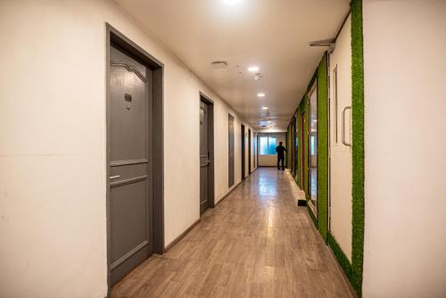 a hallway of an office building with a person walking down it at Golden Parkk Hotel in Kolkata