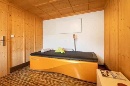 a sauna with a bench in a wooden room at Aparthotel Hummerau in Alpbach