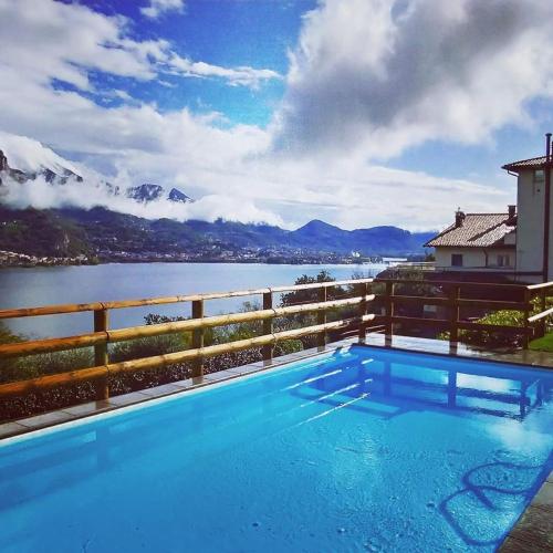 a swimming pool with a view of a lake and mountains at Hotel Ristorante Parco Belvedere in Pescate
