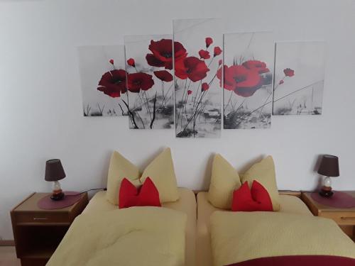 a living room with a couch and red pillows at Pension Waldeck Fleckl in Warmensteinach