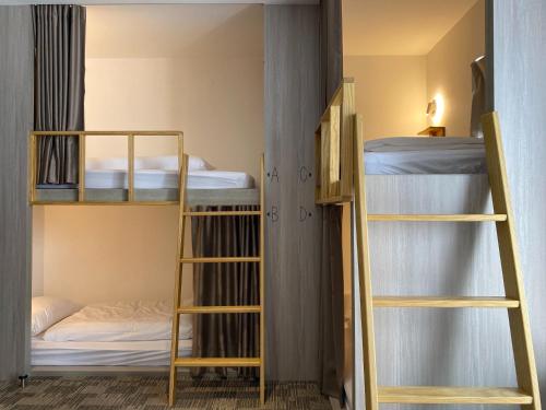 a room with two bunk beds and a bed at We Come Hostel in Taipei