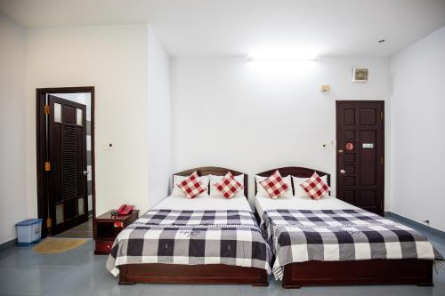 Llit o llits en una habitació de Nam A Hotel - Central City