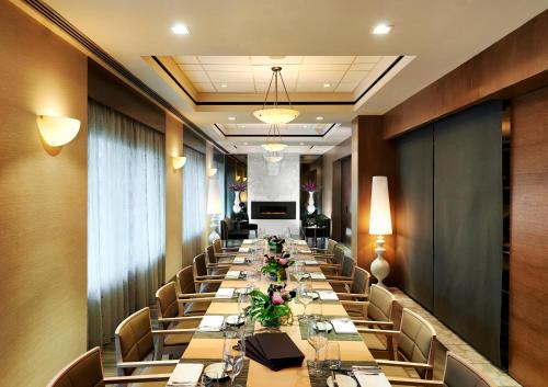 a long dining room with long tables and chairs at The Prince George Hotel in Halifax