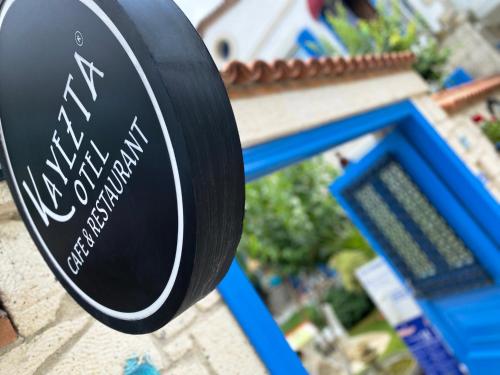 a sign for a restaurant on a building at Alacati Kayezta Hotel in Alacati