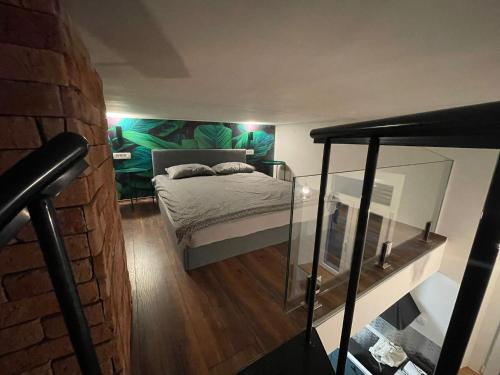 um quarto com uma cama e uma parede de tijolos em Apartment M&A - third floor em Lovran
