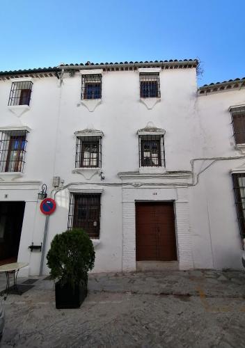 a white building with windows and a garage at Casas Las Piedras de Agua in Grazalema