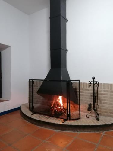 a fireplace with a fire in a room at Casas Las Piedras de Agua in Grazalema