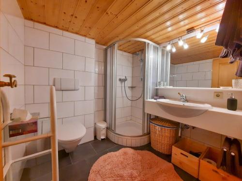 a bathroom with a shower and a sink and a toilet at Haus Schroefler in Lech am Arlberg