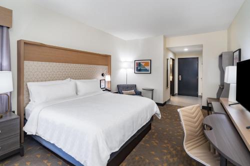 a hotel room with a large bed and a television at Holiday Inn Southaven Central - Memphis by IHG in Southaven