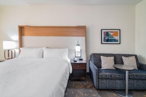 a hotel room with a bed and a couch at Holiday Inn Southaven Central - Memphis by IHG in Southaven