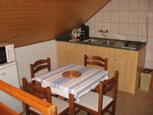 a small kitchen with a table and a sink at Balatonlelle-Kishegy in Balatonlelle