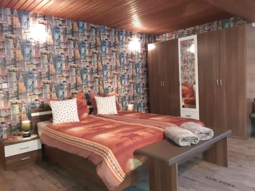 a bedroom with a large bed with a wallpaper at Ferienwohnung Atlantis in Hemfurth-Edersee