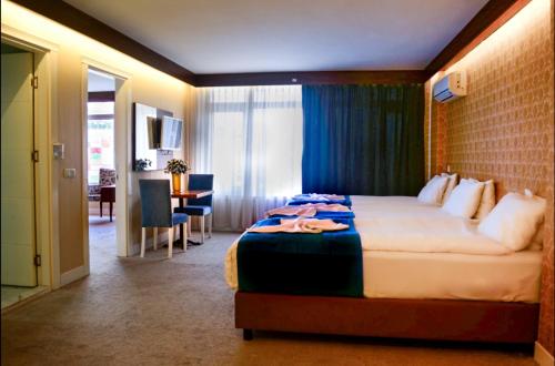 a hotel room with a bed and a dining room at Bilgehan Hotel in Antalya