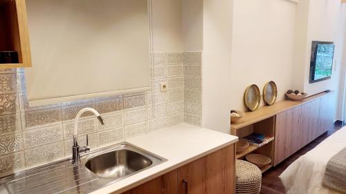 a kitchen with a sink and a counter top at Loutraki Hidden Gem Ι in Loutraki