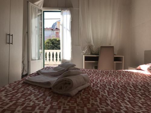 菲納萊利古雷的住宿－Hotel B&B Giardino delle Rose Bike&Breakfast，一间卧室配有带毛巾的床