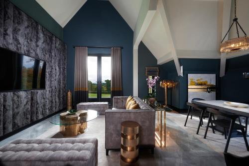 a living room with a couch and a table at Aldwark Manor Estate in Aldwark