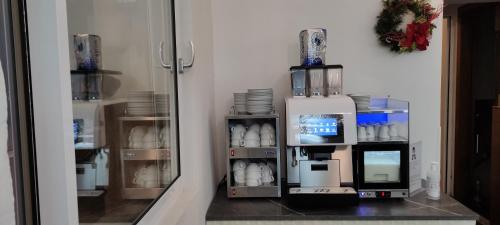 a room with a coffee machine and a tv at Hotel Lido in Varazze