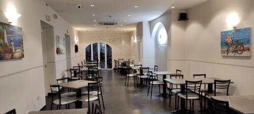 a restaurant with tables and chairs in a room at Hotel Lido in Varazze