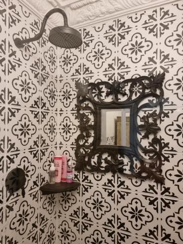 a bathroom with a mirror on a wall at La Casa Nostra Villa Rose Garden Carmella in Hillcrest