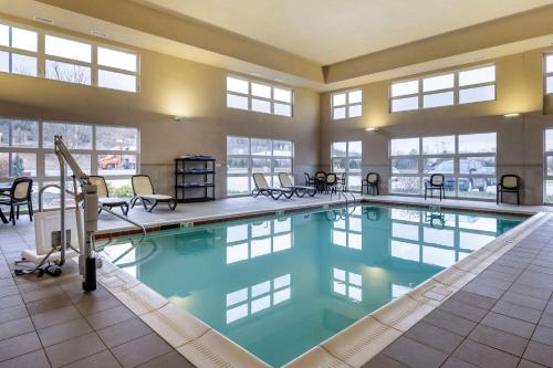 a large swimming pool in a building with windows at Comfort Inn & Suites Northern Kentucky in Wilder