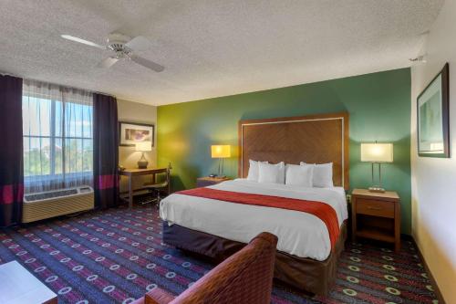 a hotel room with a large bed and a window at Comfort Inn West Valley - Salt Lake City South in West Valley City