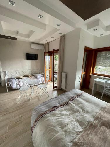 a bedroom with a large bed and a table at B&B IL CAVALIERE in Baronissi