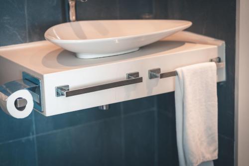 a bathroom with a sink and a bowl on a shelf at Atik Hotel in Unye