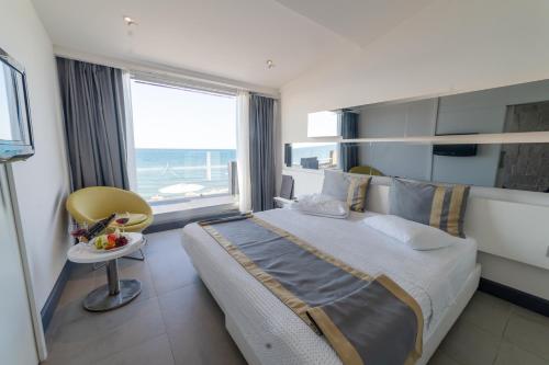 a bedroom with a large bed and a large window at Atik Hotel in Unye