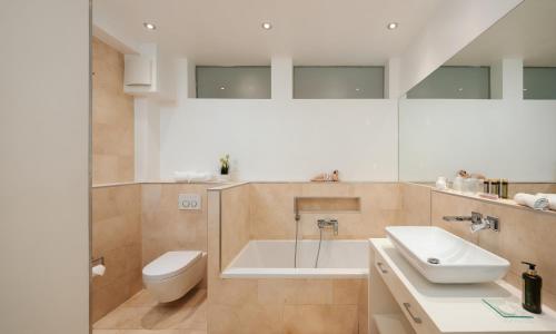 a bathroom with a white sink and a toilet at 120qm Deluxe Apartment Suites Christina im Stil Design Hotel Vosteen Nähe der Kaiserburg in Nürnberg