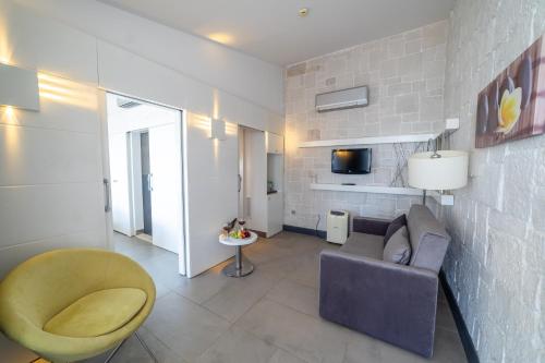 a living room with a couch and a chair at Atik Hotel in Unye