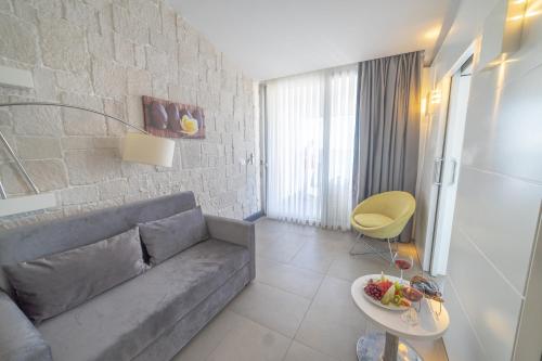 a living room with a couch and a table at Atik Hotel in Unye